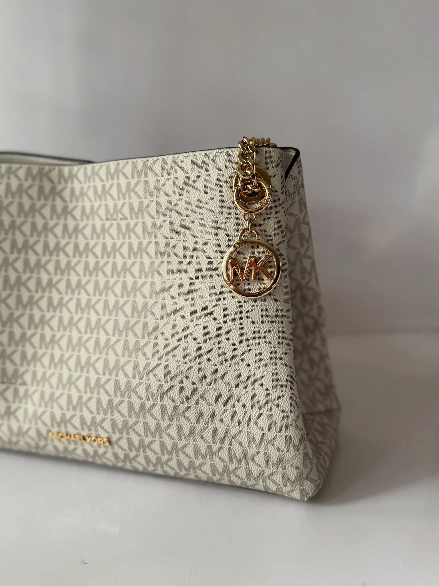 Cream Michael Kors logo-print bag with gold-tone medallion