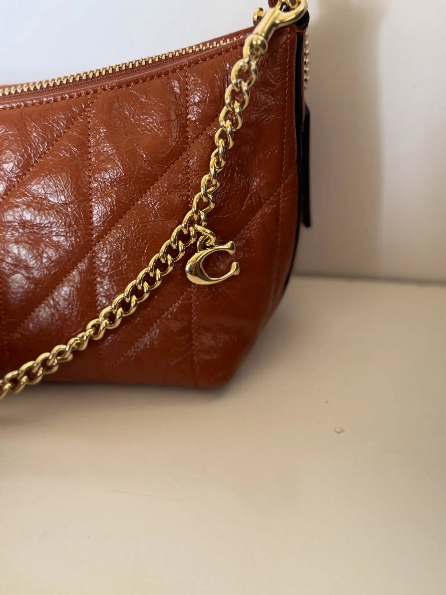 Brown quilted Michael Kors bag with gold-tone chain strap